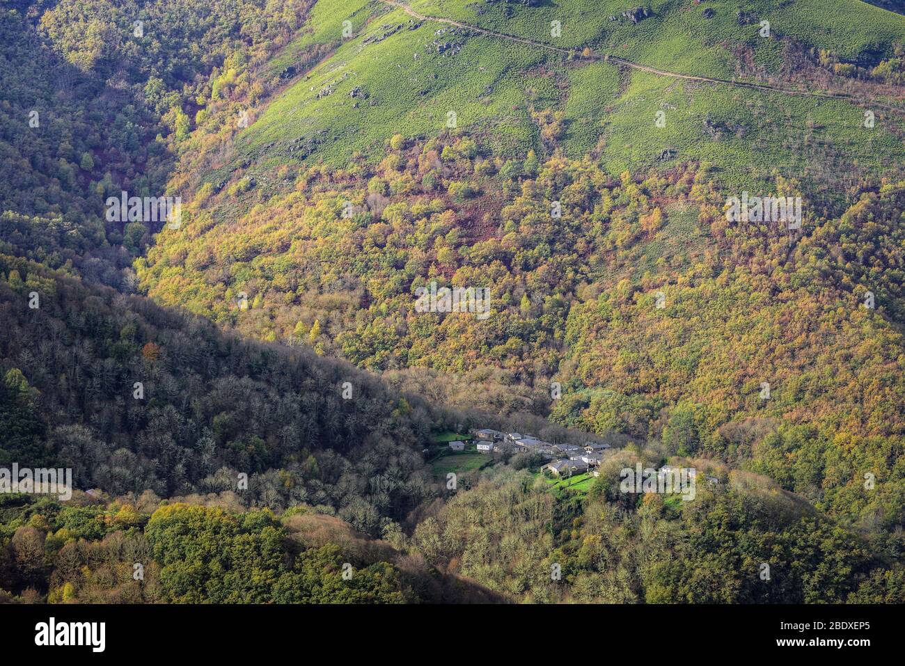 Small farmers village in a clearing among extensive deciduous forests in Courel Mountain Range Geopark Stock Photo