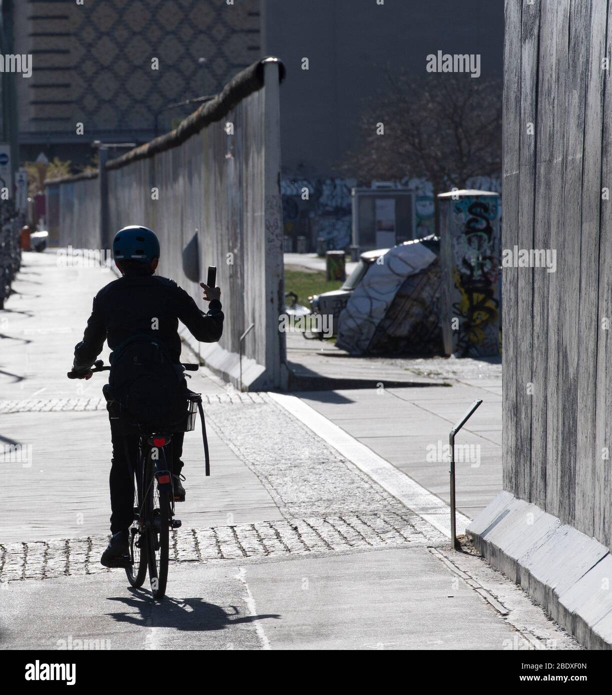 Berlin, Germany. 10th Apr, 2020. A woman rides her bike along the East ...