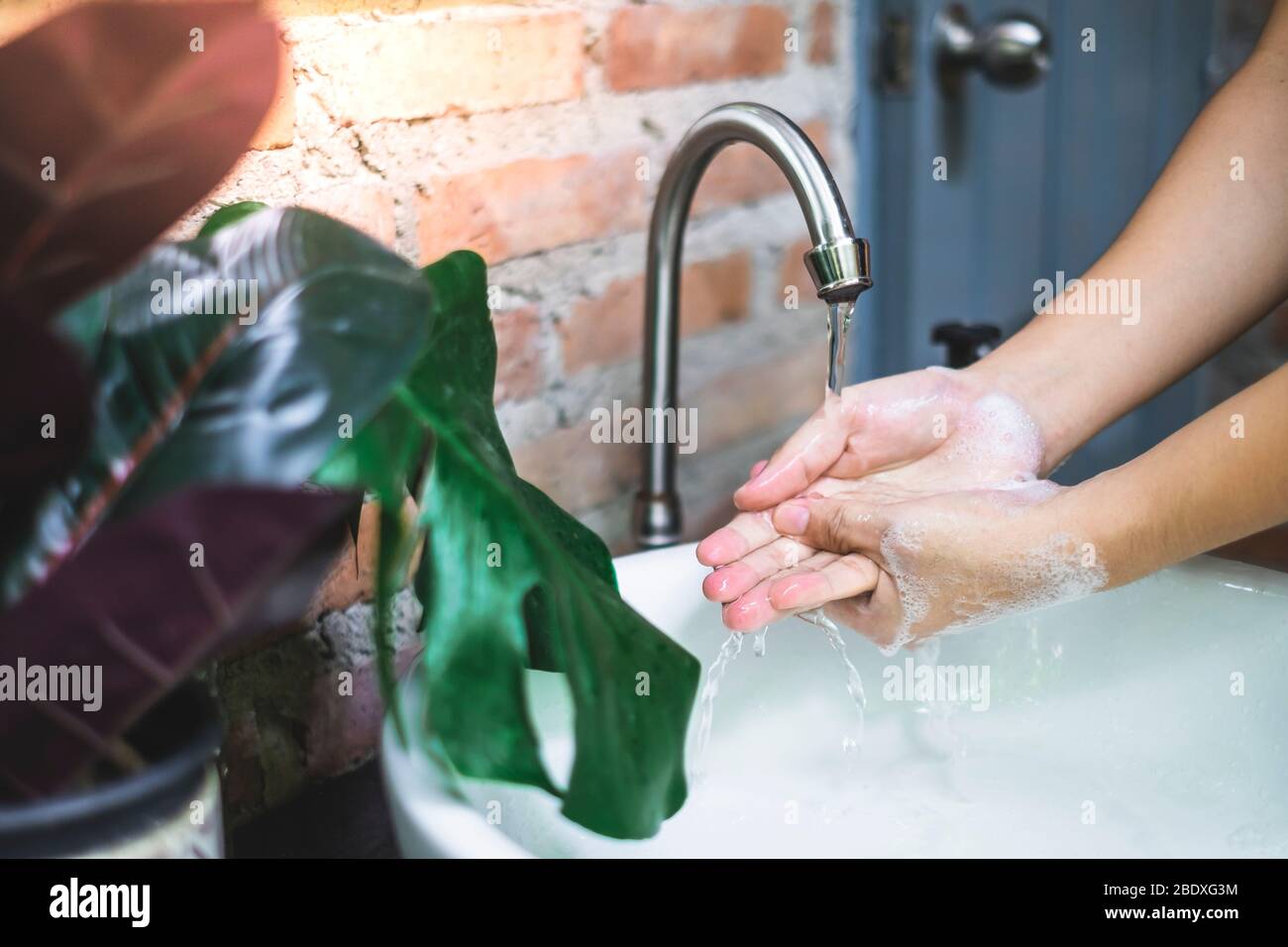 Rinse hands under running water. Washing hands is the most effective ways to prevent the spread of germs. Stock Photo