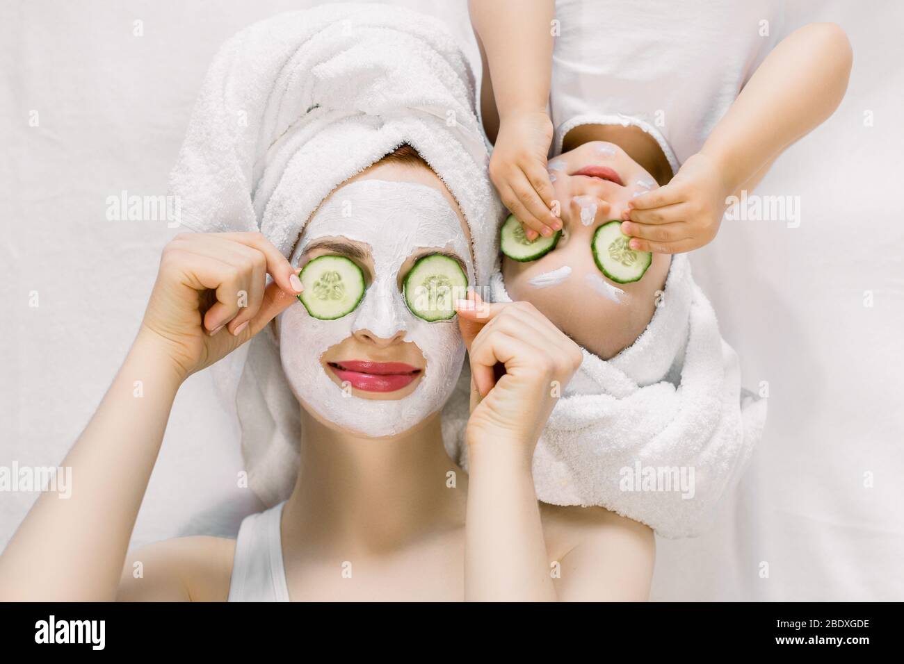 Mom and her 2 years old baby girl having fun together, making clay