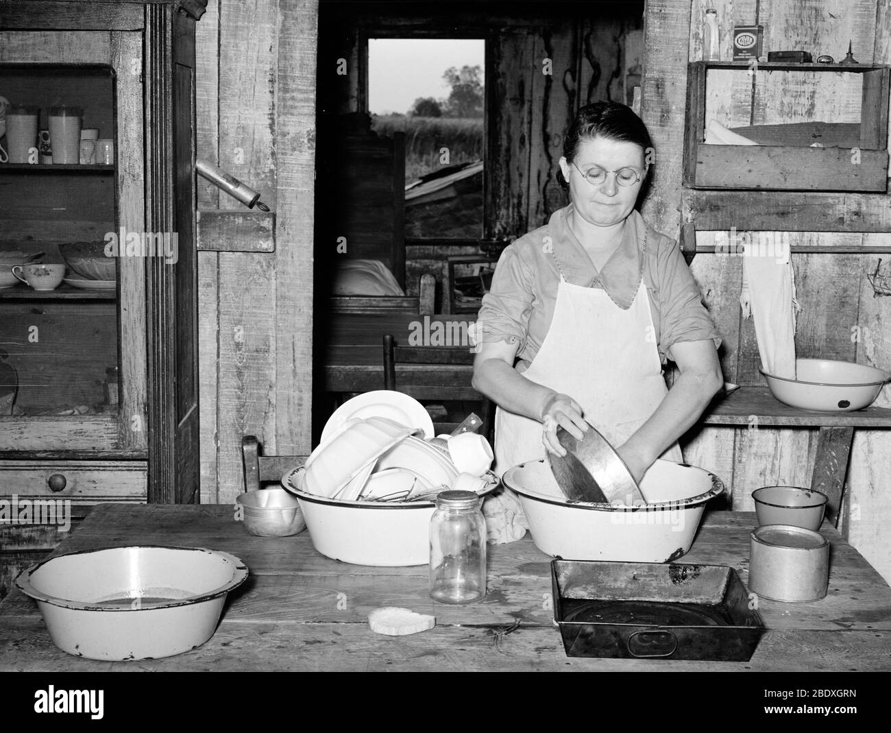 Housewife Washing Dishes, 1938 Stock Photo
