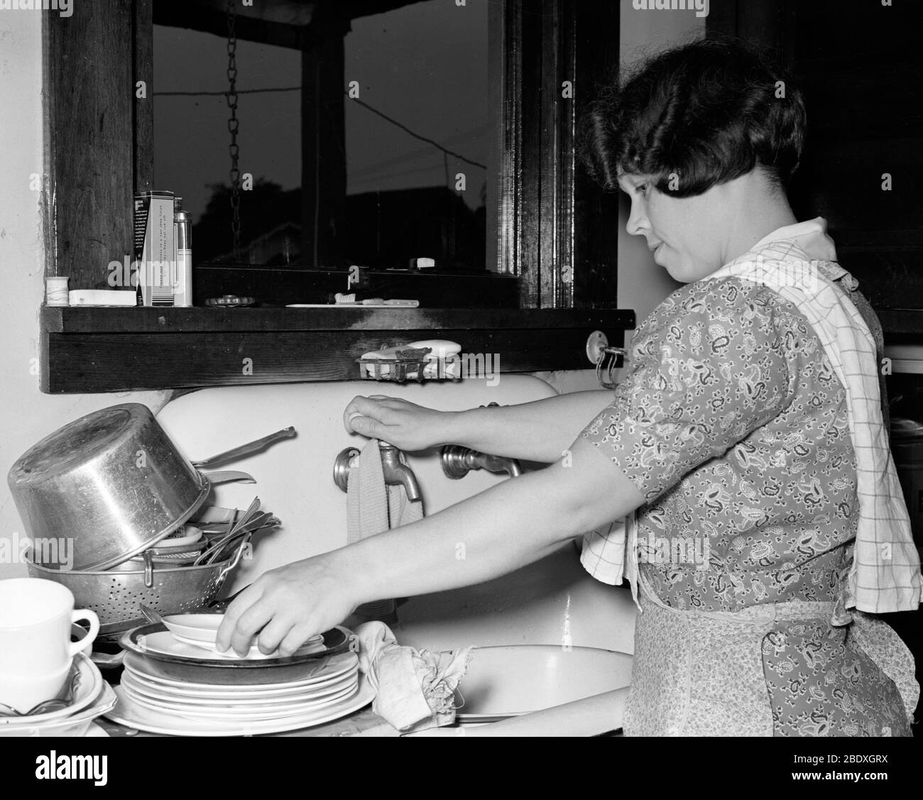 Housewife Washing Dishes, 1938 Stock Photo