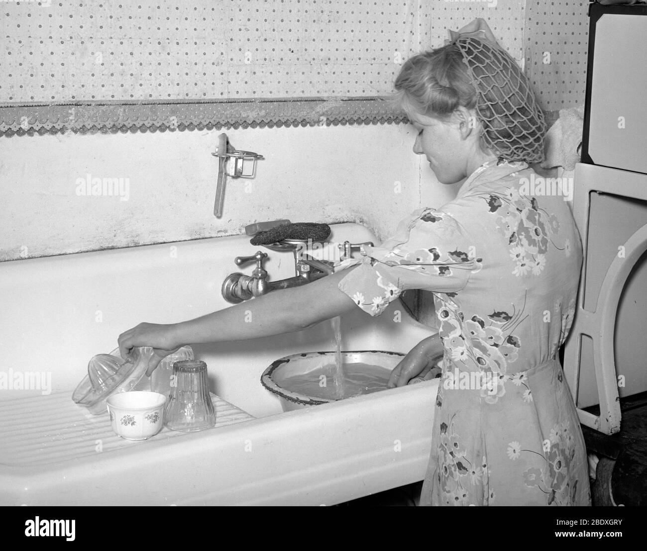 Daughter Washing Dishes, 1940 Stock Photo