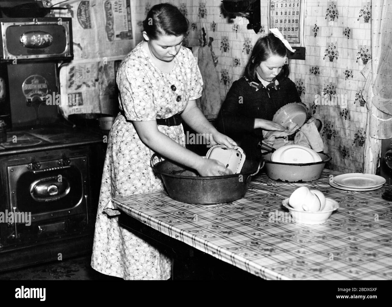 Sisters Washing Dishes, 1937 Stock Photo