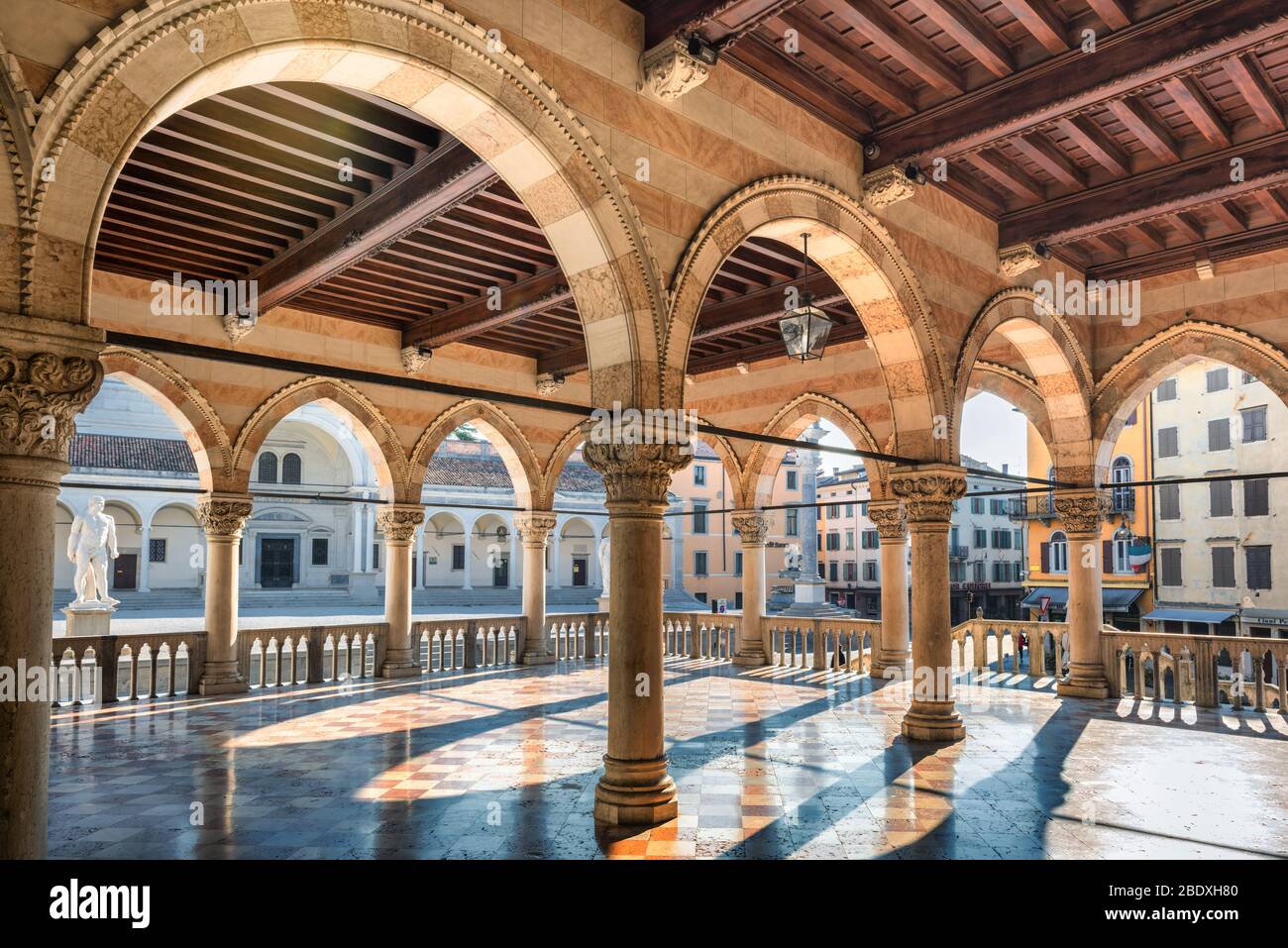 Italian architecture. View of 'Loggia del Lionello' with colonnade in background. Udine, Friuli Venezia Giulia, Italy. Stock Photo