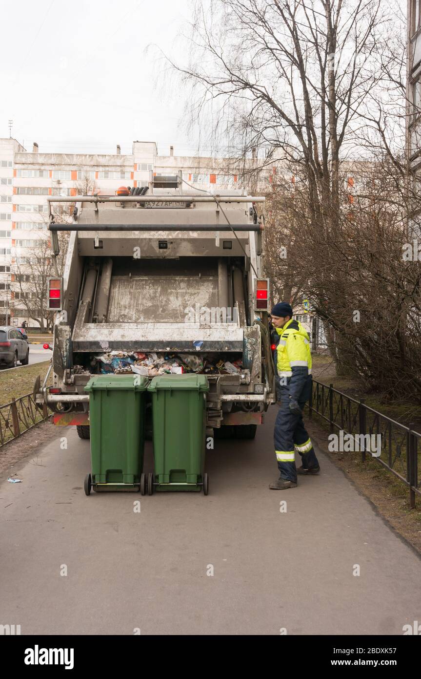 St. Petersburg, Russia - 03.10.20: a worker of a municipal waste recycling plant prepares garbage bins for loading. Stock Photo
