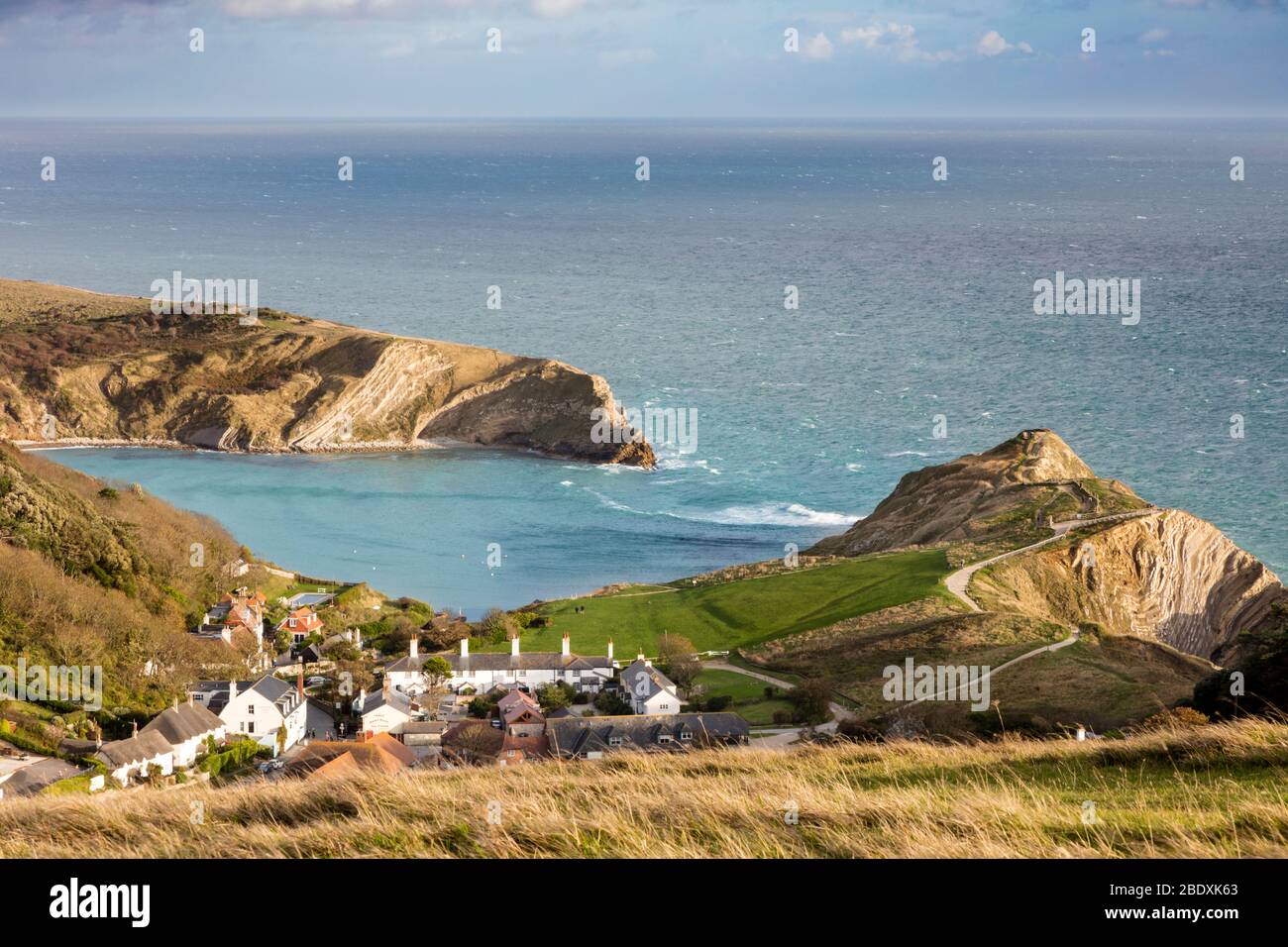 Lulworth Cove and village of West Lulworth along the Jurassic Coast, Dorset, England, UK Stock Photo