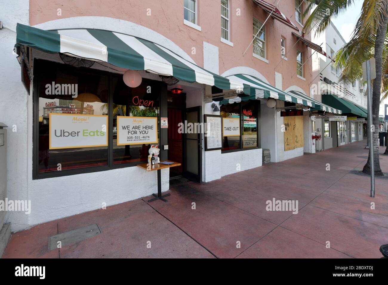 Miami, Florida, USA. 10th Apr 2020. Miami Beach has an Eerie calm and quiet to it as tourist attractions and hot spots like Ocean Drive, Lincoln Road, The Design District and the Wynwood Art District all are empty as businessÕs and Florida economy come to a total halt after Florida Gov. Ron DeSantis orders all entertainment venues, restaurants, and beaches to close in Dade, Broward and Palm Beach Counties in the name of public safety an in an effort to slow the spread of the Coronavirus on April 10, 2020 in Miami Beach, Florida People: Washington Ave Credit: Storms Media Group/Alamy Live Ne Stock Photo