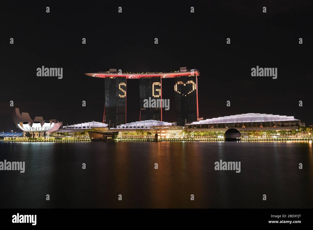 APR 10, 2020 - Covid-19: Hotel room lights make SG love at Marina Bay Sounds Hotel: #SGUnited Together We can overcome after Singapore government has announced Circuit Breaker measurement take effect from 07 Apr to 04 May of the COVID19 novel coronavirus Stock Photo