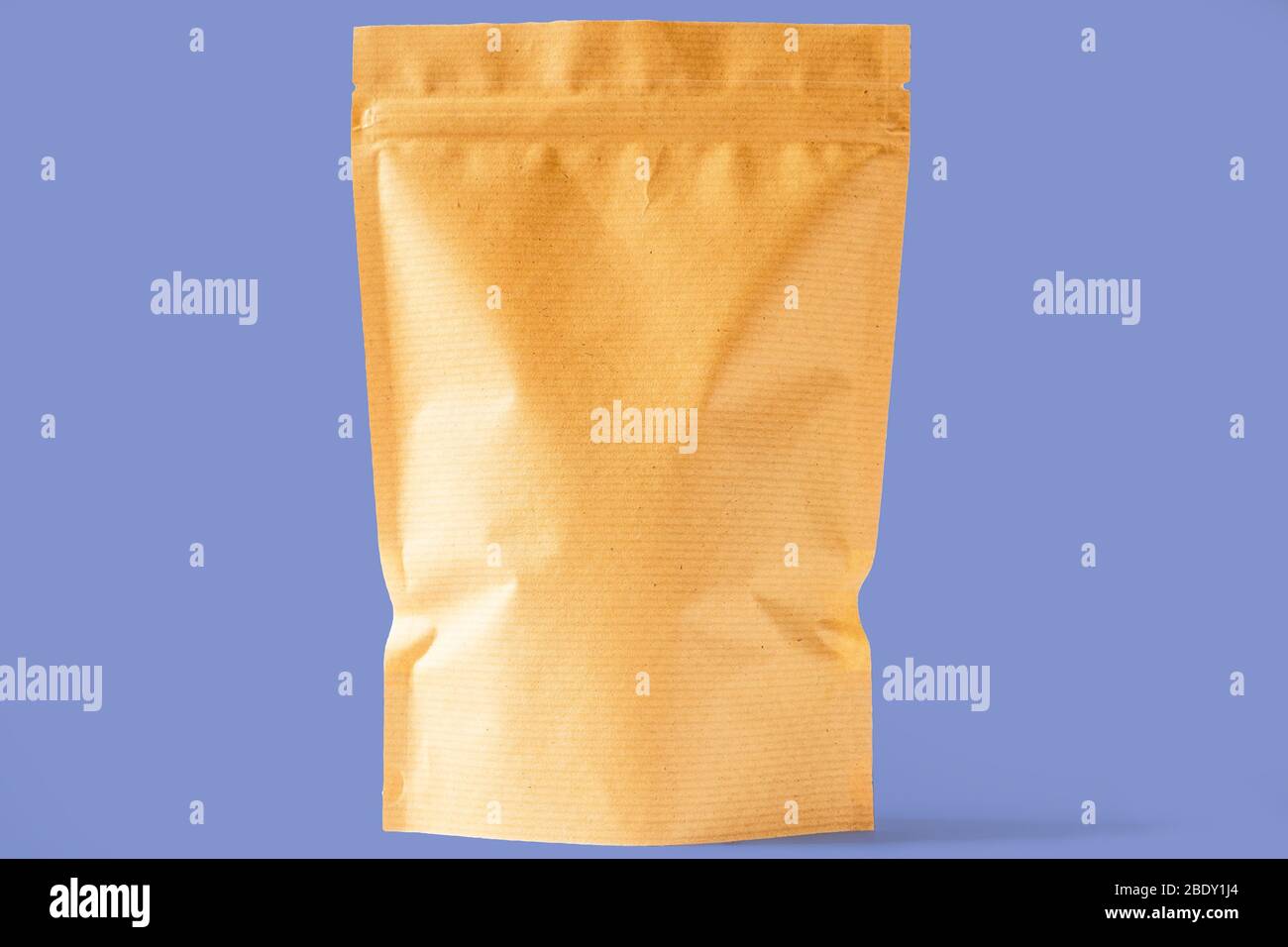 brown striped paper doy pack stand up bio pouch with zipper on blue background Stock Photo