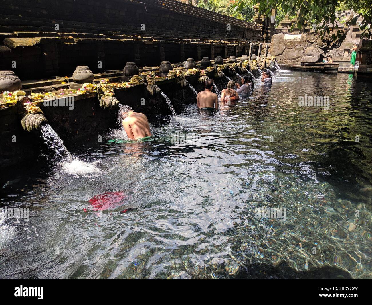 APRIL 23, 2019-BALI INDONESIA : people taking a bath in fountains of sacred waters in Tirta empul temple. Religion and culture. Stock Photo