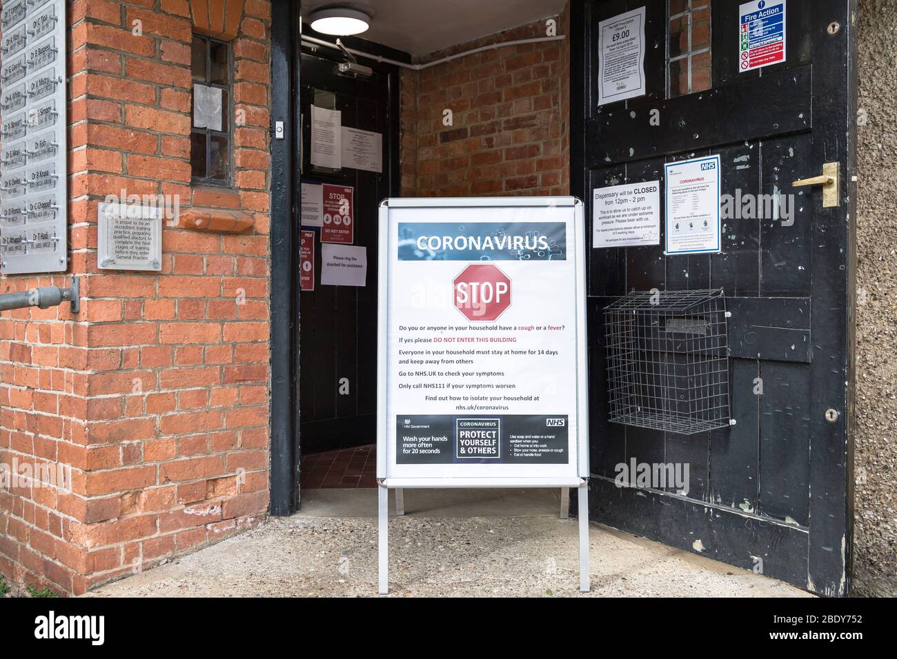 BUCKINGHAM, UK - March 30, 2020. Coronavirus COVID-19 warning sign with prevention information outside a GP doctor surgery Stock Photo