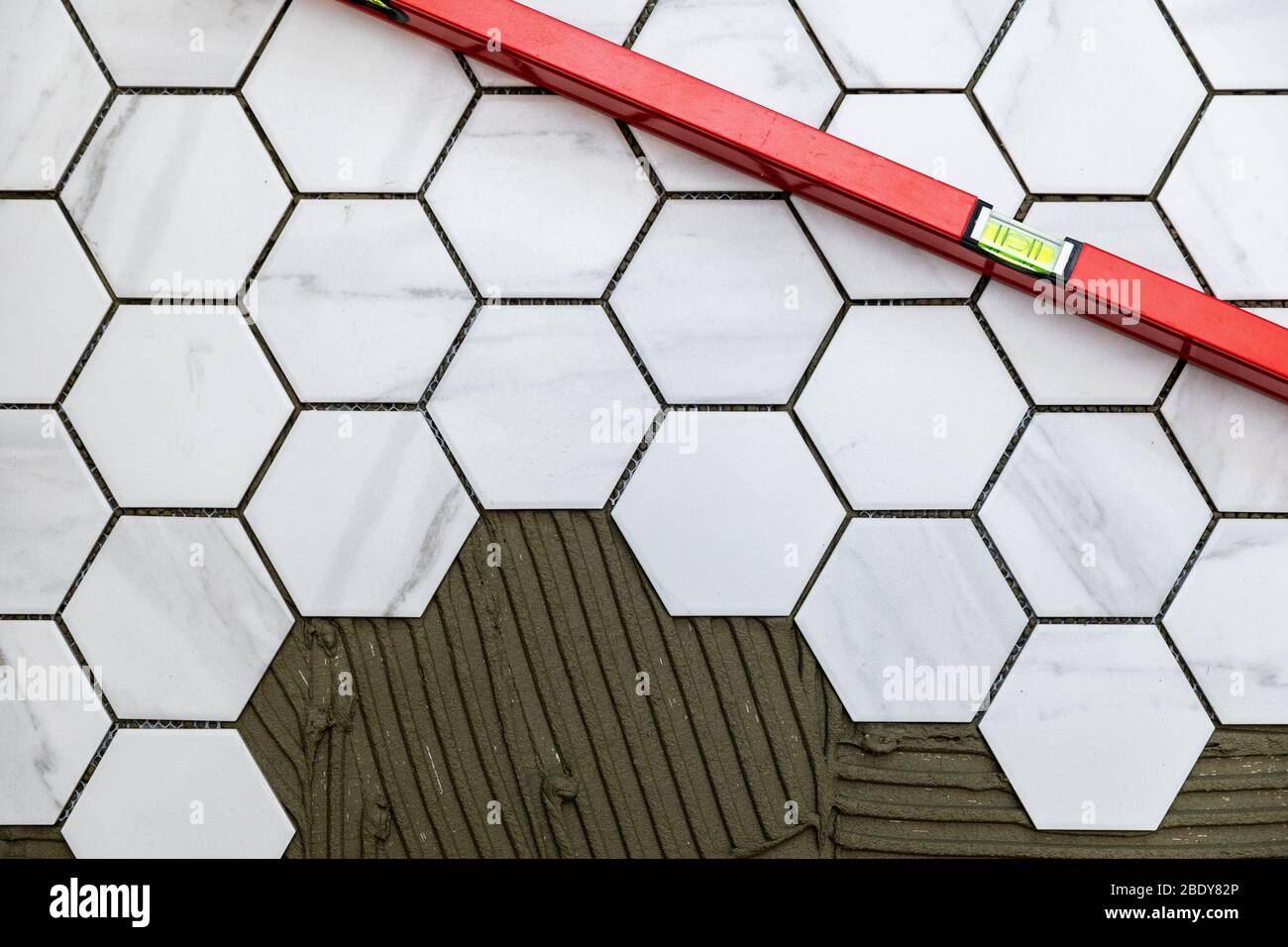 tiling - laying marble texture hexagon tiles on the floor Stock Photo