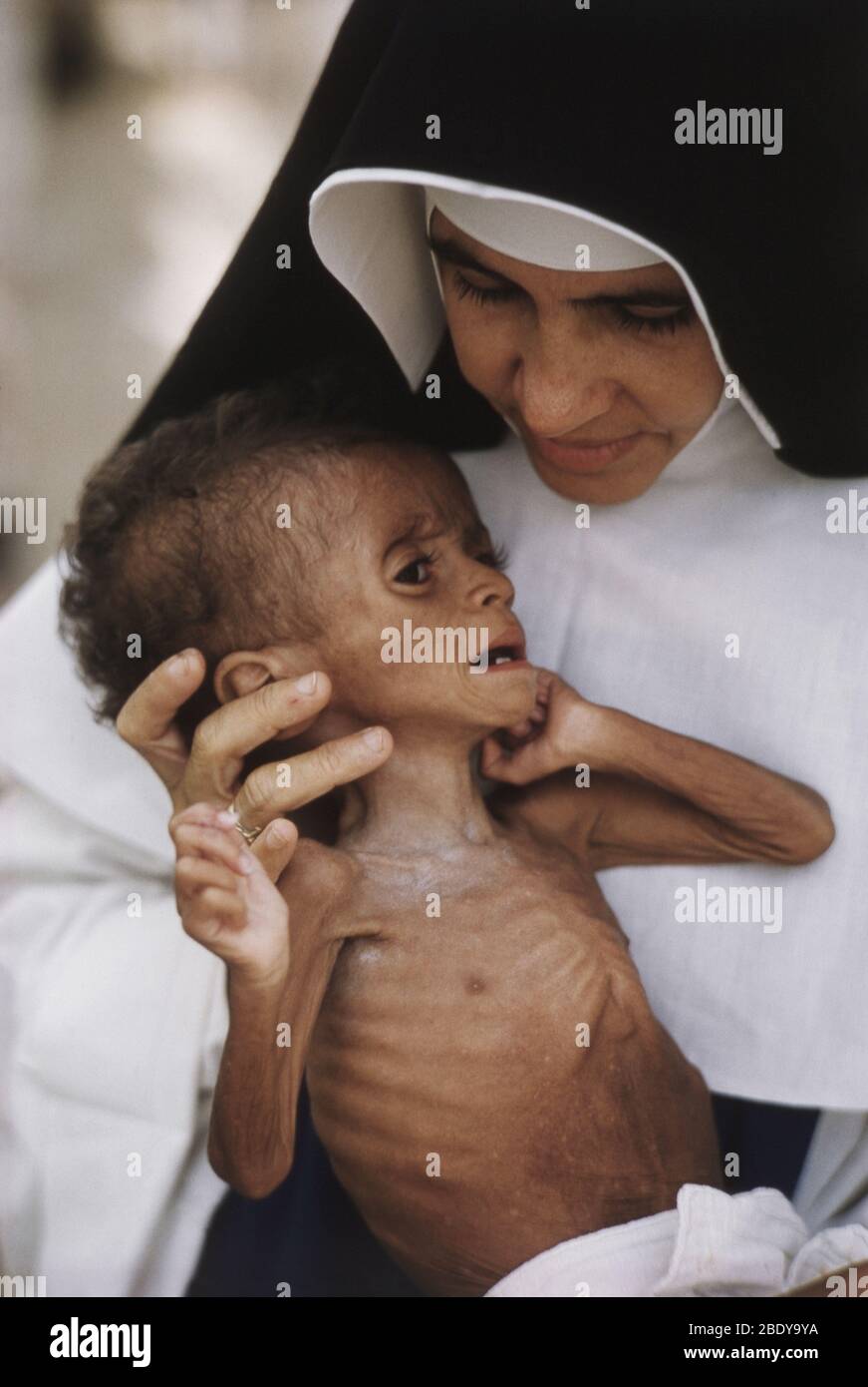 Nun Holding Starving Baby Stock Photo