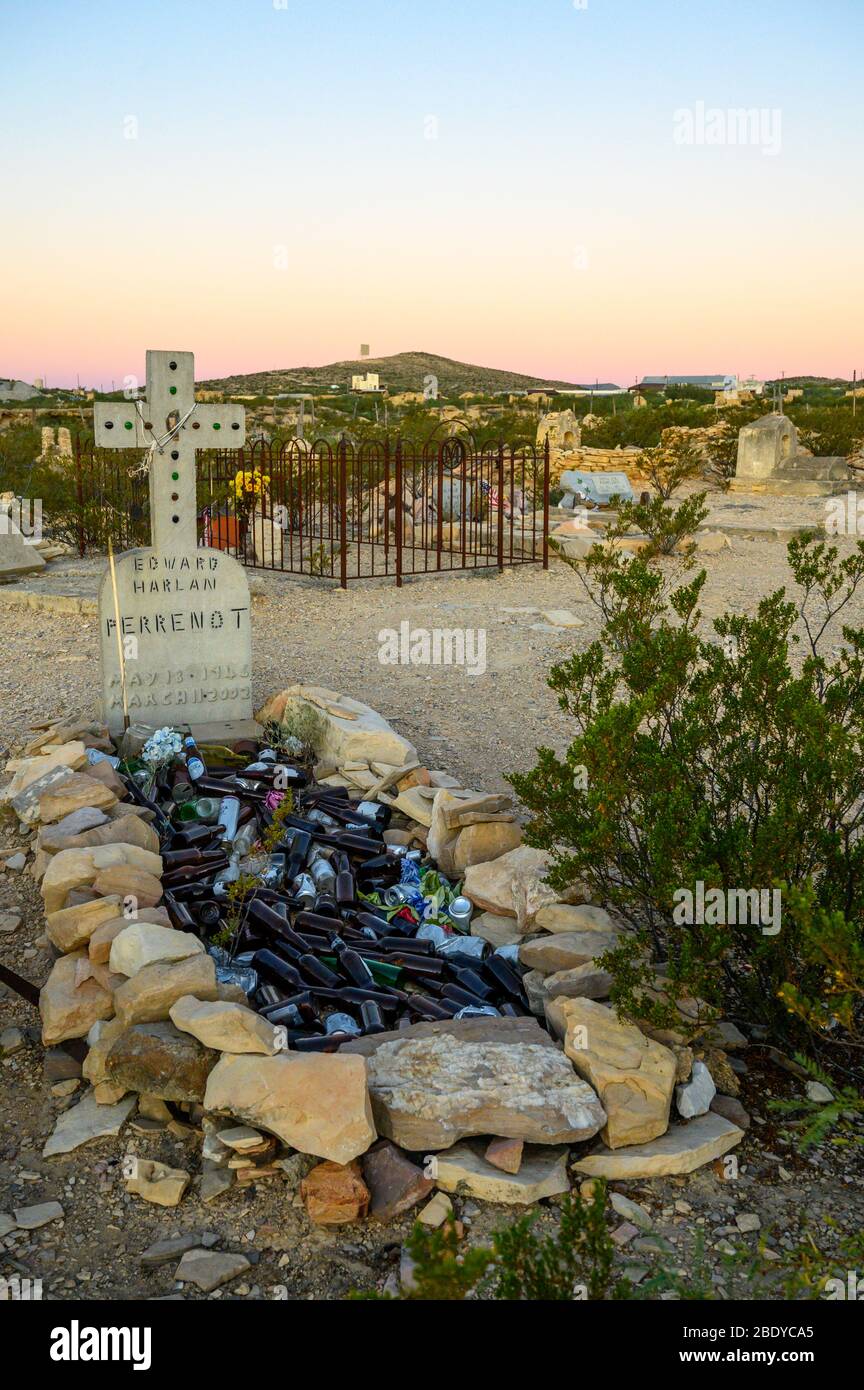 Glass bottles cover this grave in the Terlingua Cemetery in West Texas, where the graves are marked by handmade embellishments. Stock Photo