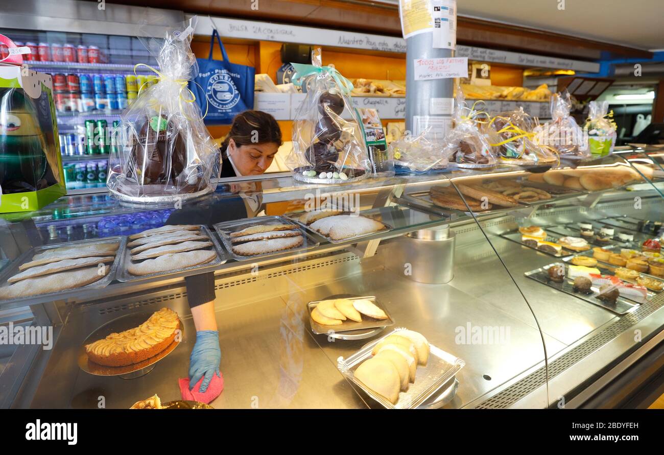 Port Andratx, Spain. 10th Apr, 2020. Baker Ana cleans the display in her  bakery. Bakeries, supermarkets, pharmacies and tobacco and press vendors  are the only shops that are allowed to stay open