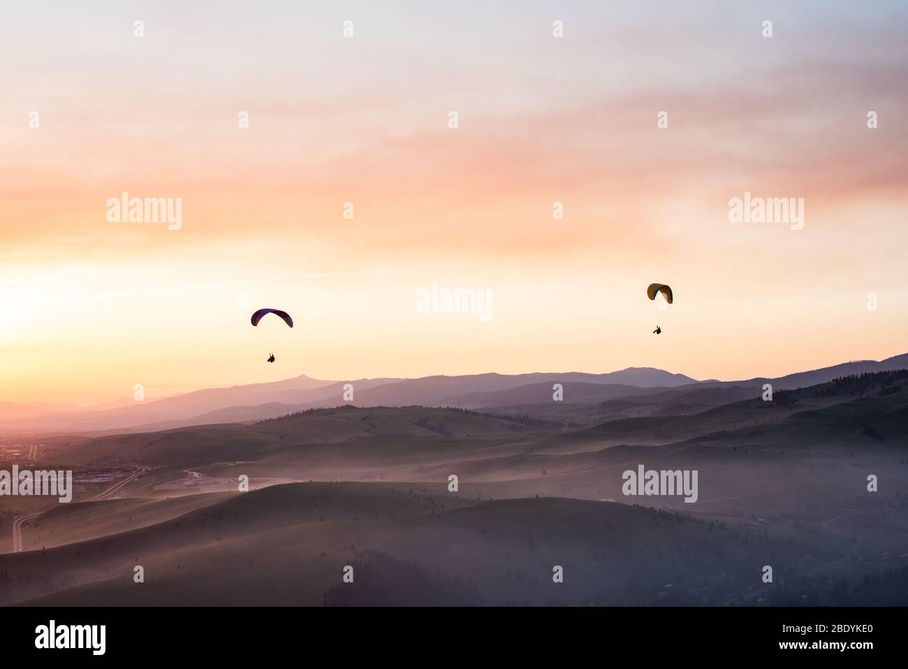 Paragliders floating above Missoula MT in May 2018. Stock Photo