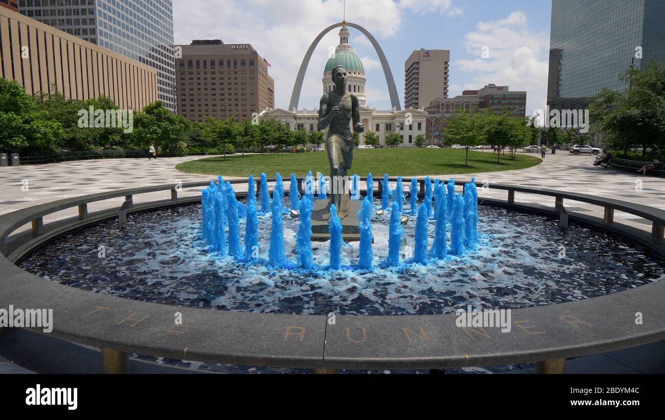 Blue water fountain with Runner Statue at Kiener Plaza Park in St