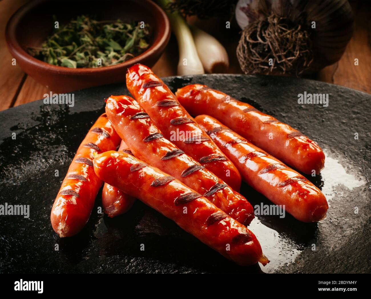 delicious and crispy little chorizo sausages on a hot platter Stock Photo