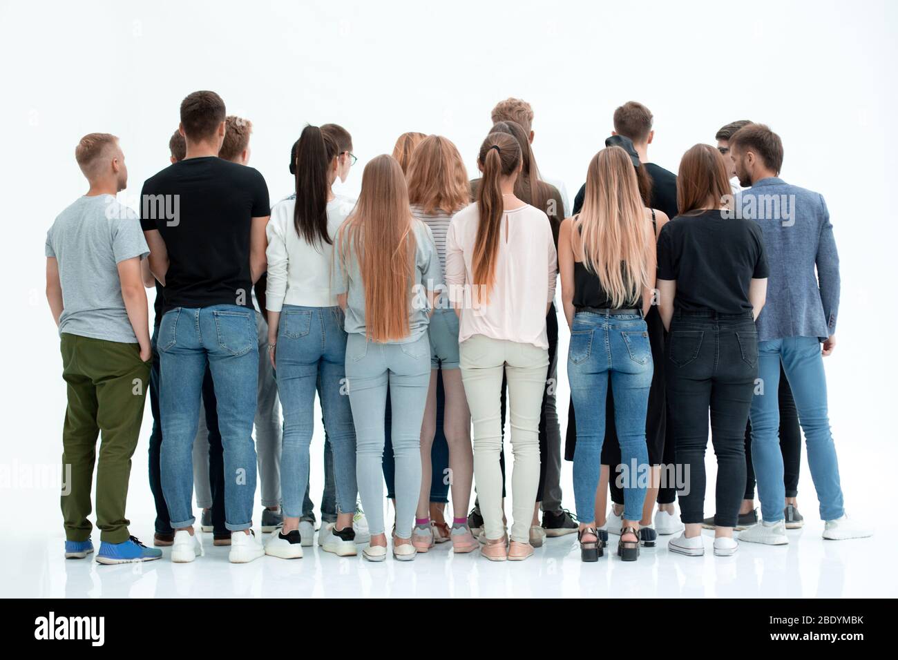 group of diverse young people standing in front of a white wall Stock ...