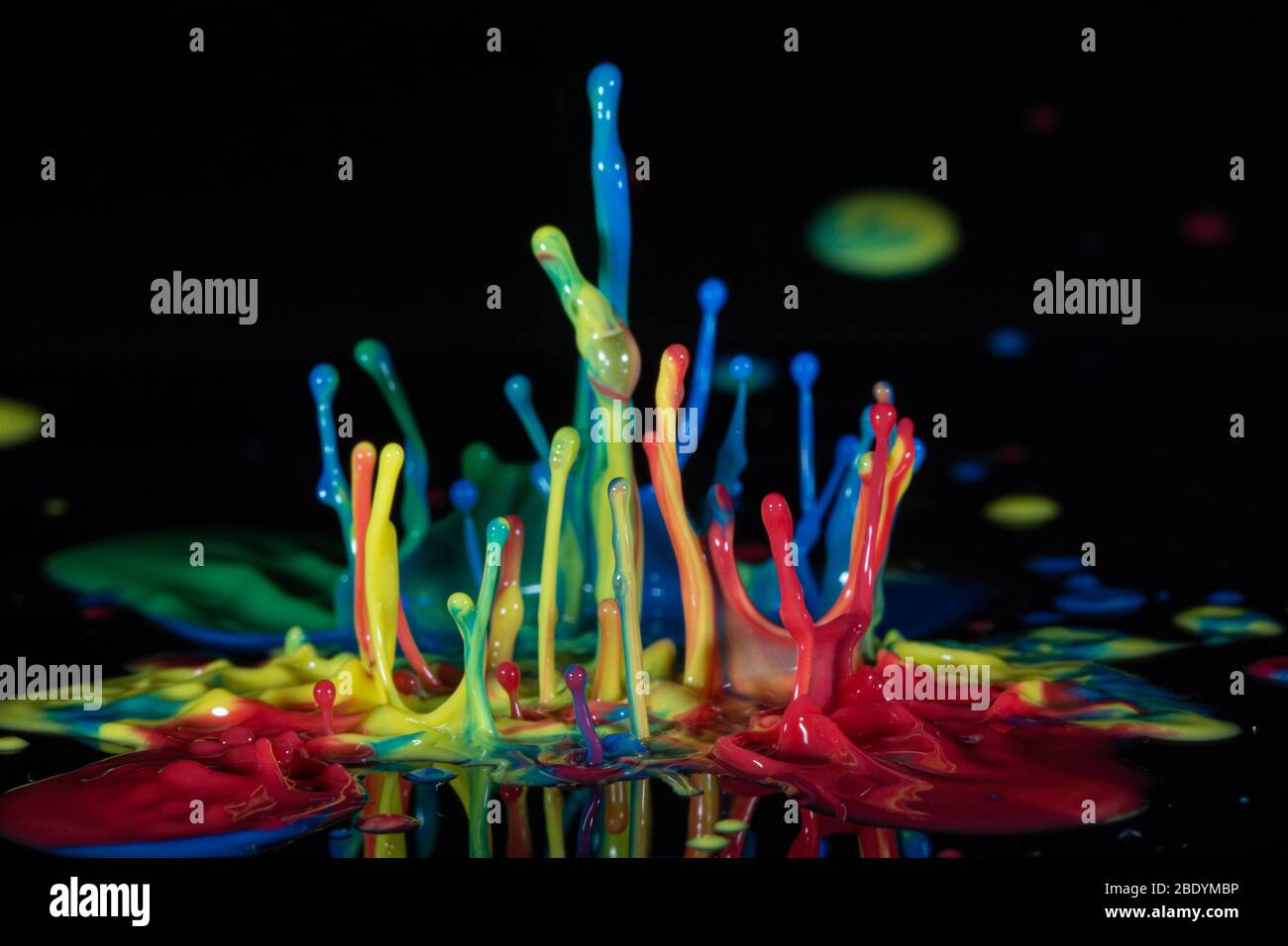Color ink splash on a black background Stock Photo - Alamy