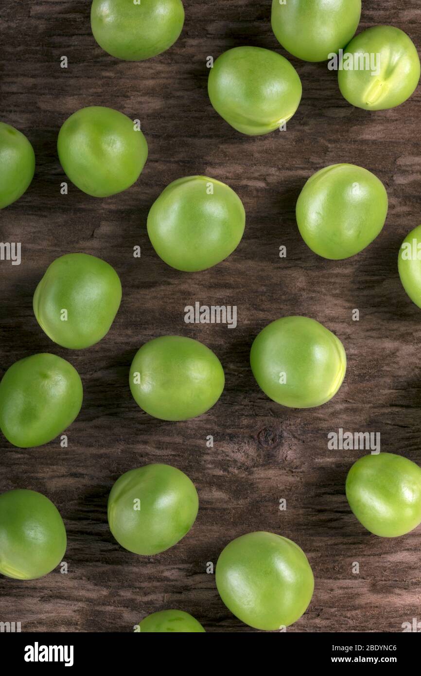 Close up of freshly picked peas on a wooden table. Stock Photo