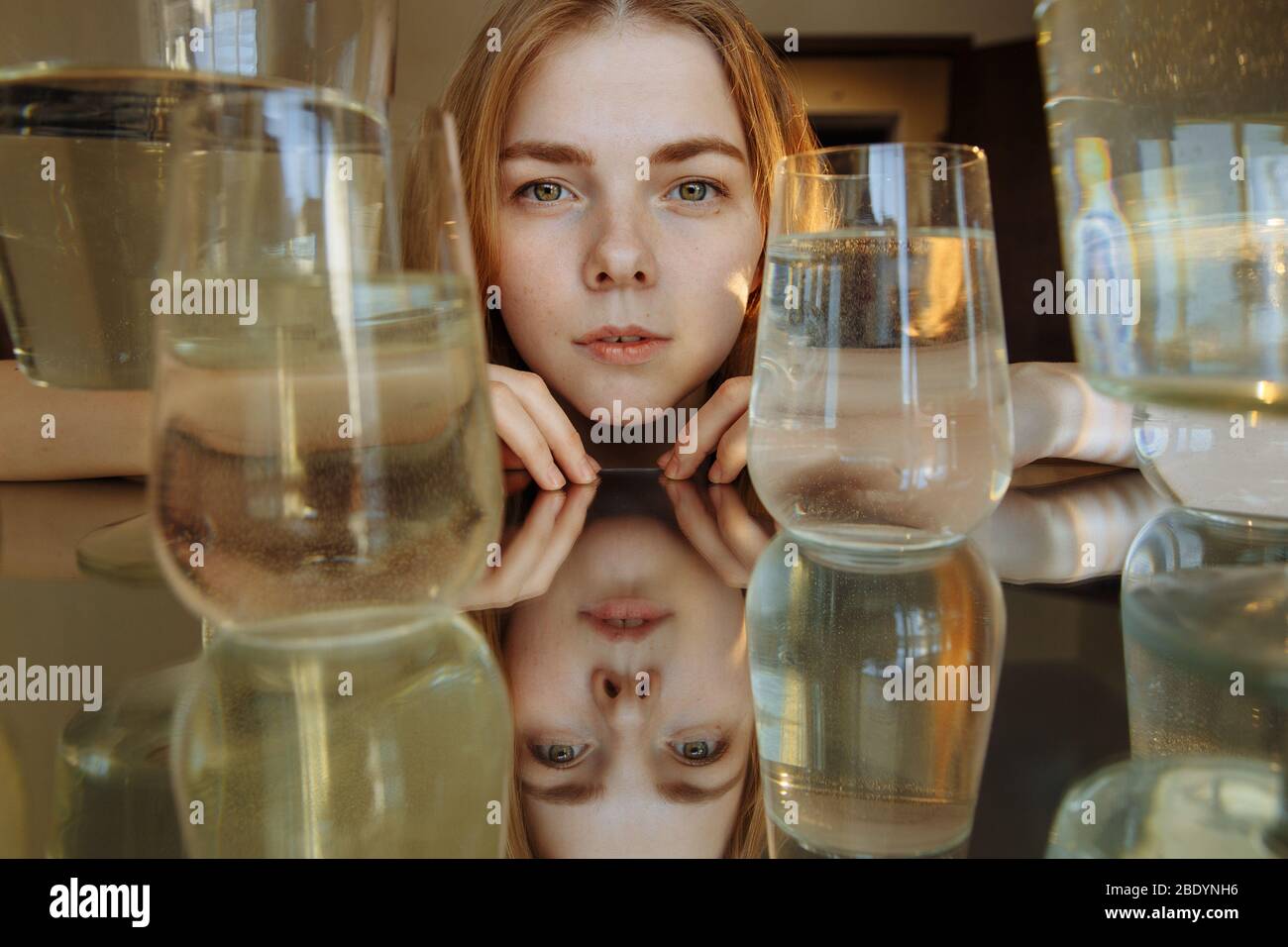 The girl looks at the camera. The face of a Girl with yellow eyes is