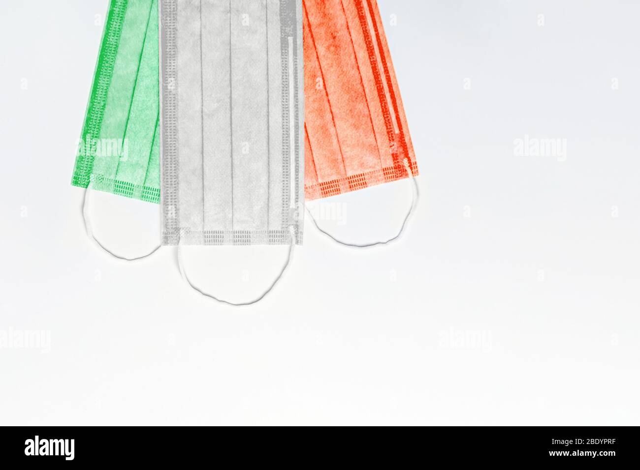at the top are masks of green, white and red colors on a light background. Italy flag made of medical masks. pandemic concept in italy. quarantine due Stock Photo