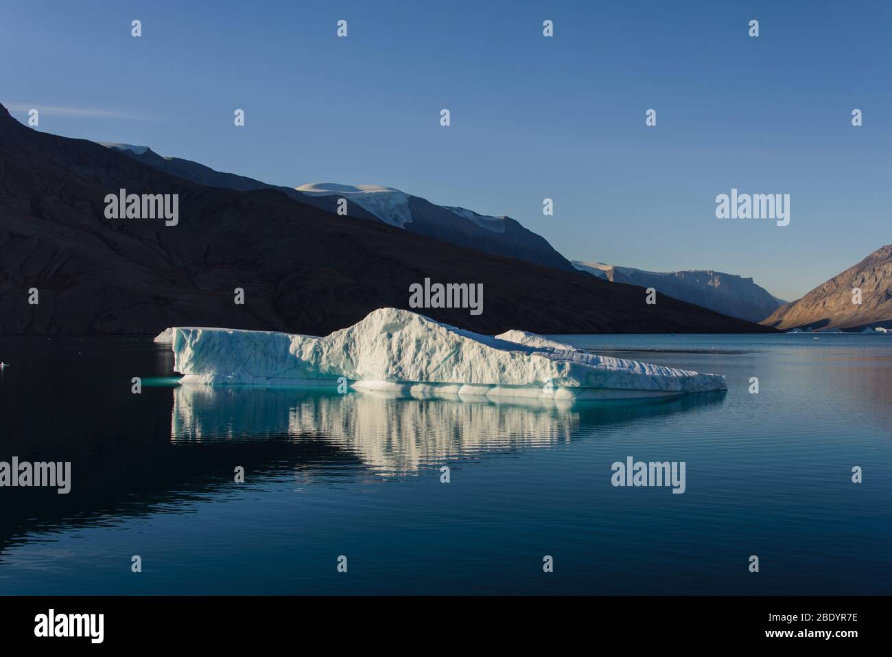 Greenland Coastal Rocks Greenland landscape with beautiful coloured rocks and iceberg Stock ...