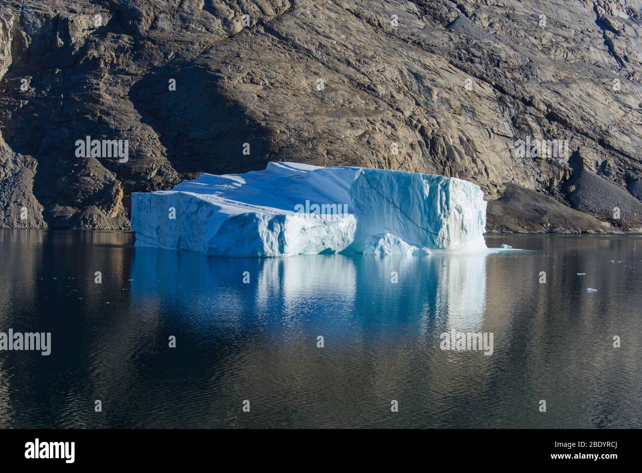 Greenland Coastal Rocks Greenland landscape with beautiful coloured rocks and iceberg Stock ...