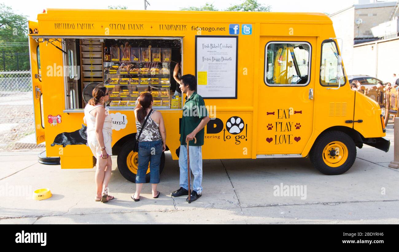 People standing by dog food truck, Chicago, Illinois, USA Stock Photo