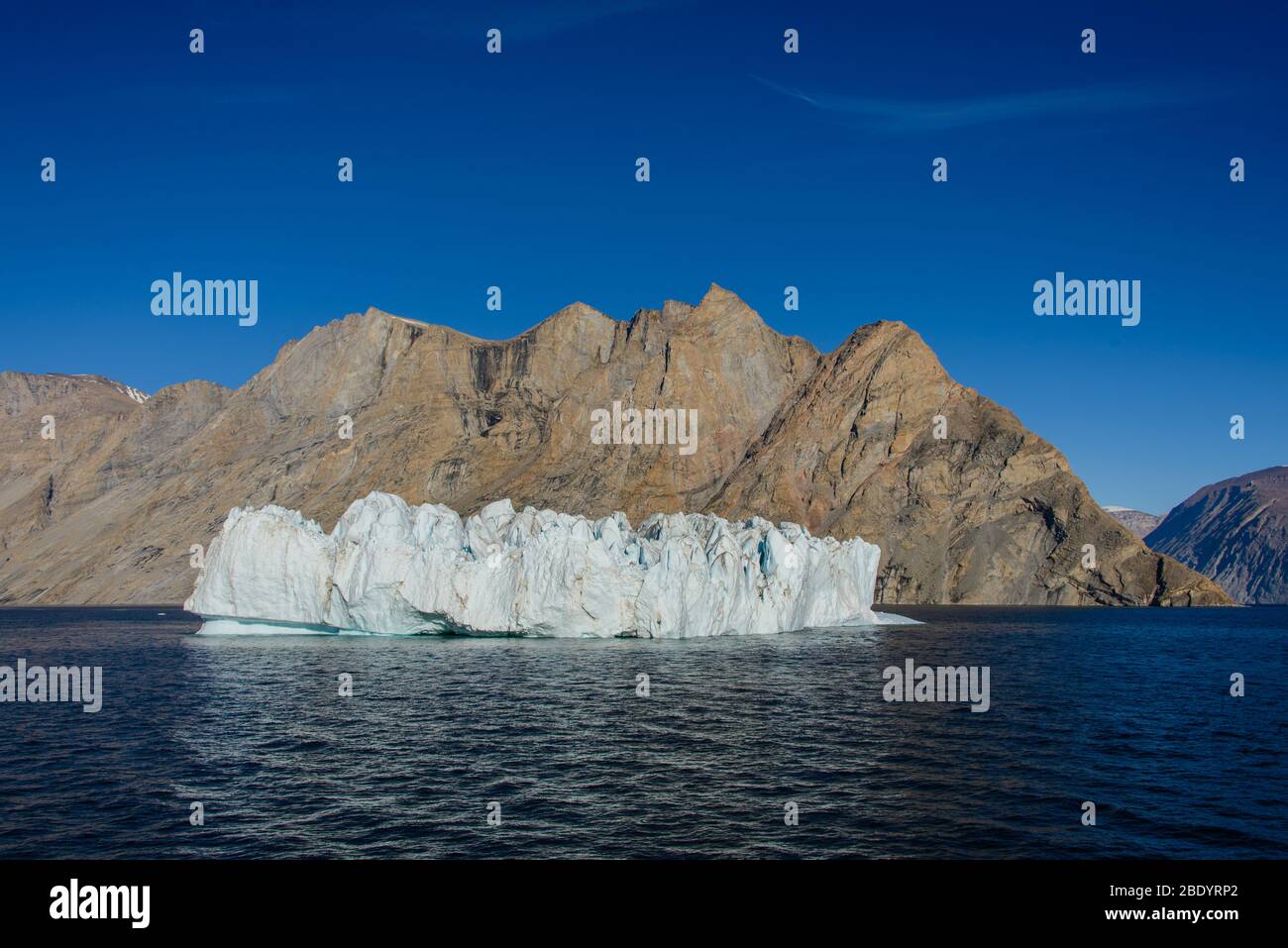 Greenland Coastal Rocks Greenland landscape with beautiful coloured rocks and iceberg Stock ...