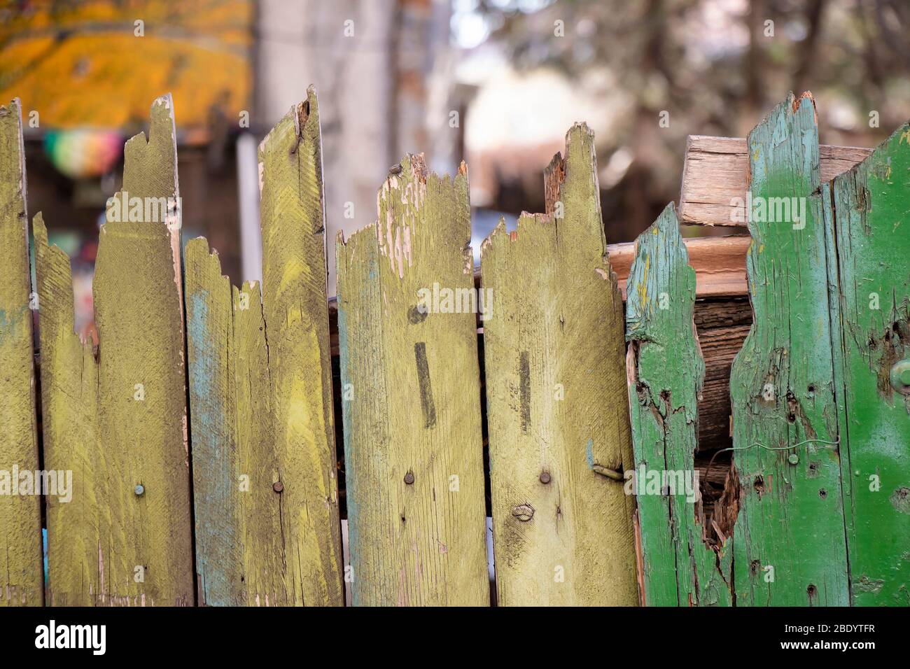 Detail of old nailed rusty wooden fence with green color peeling off Stock Photo