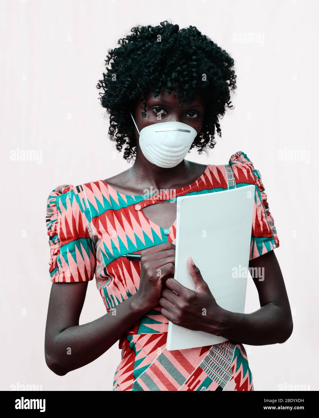African Body Shot of Doctor Woman Posing with Facemask and Notebook Stock Photo