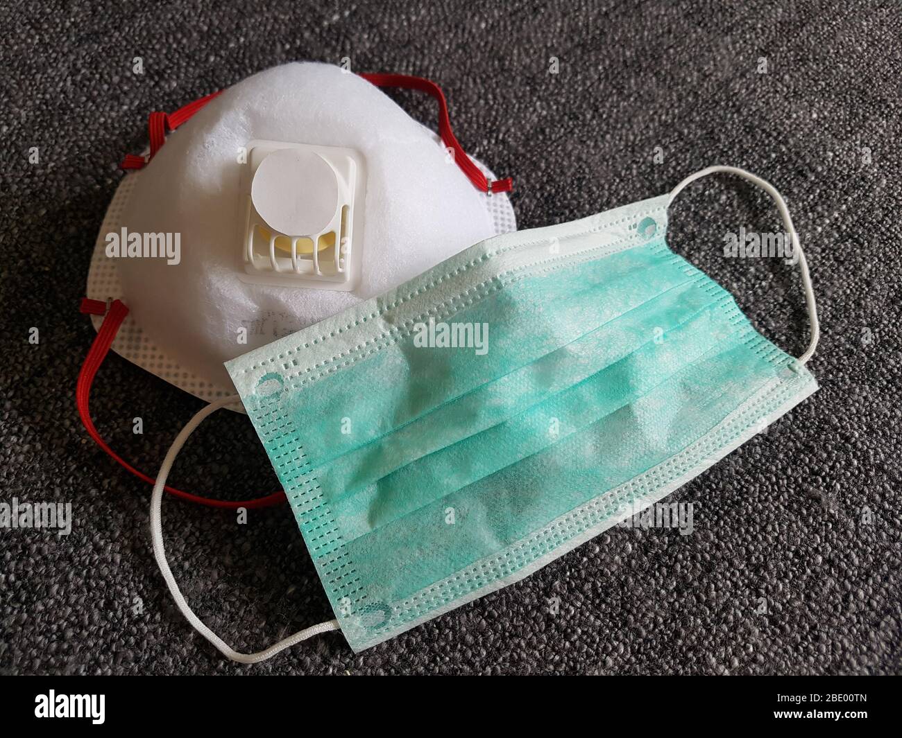 Differerent face mask variants - dust respirator ffp3 & green surgical mask used by hospitals / doctors / nurse for protection - corona virus covid-19 Stock Photo