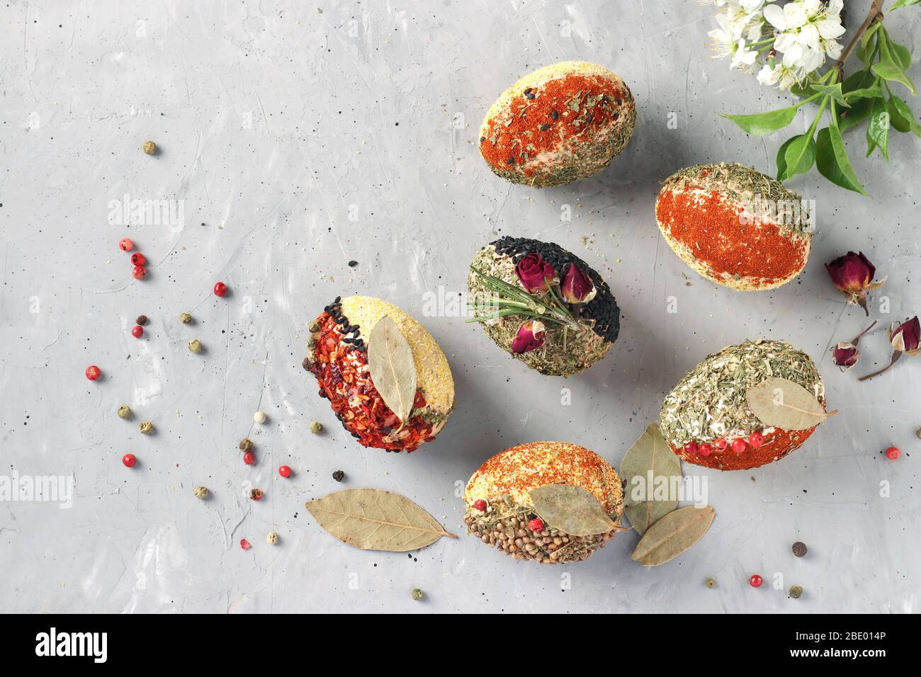 Eco-design of Easter eggs with various spices and cereals, without dyes and preservatives on a gray concrete background, Top view Stock Photo