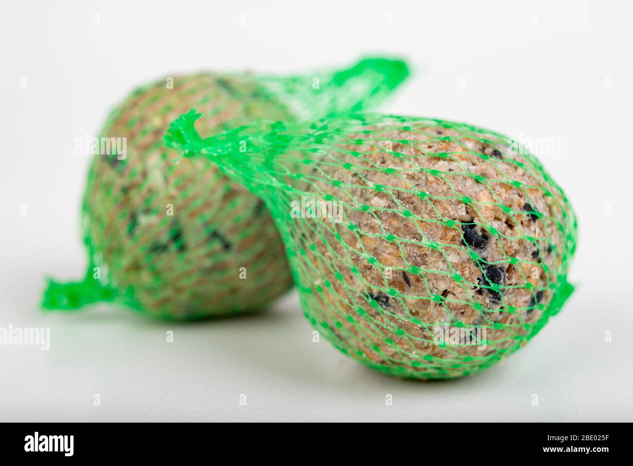 Bird food formed into balls. Food for birds in the grid. Light background Stock Photo Alamy