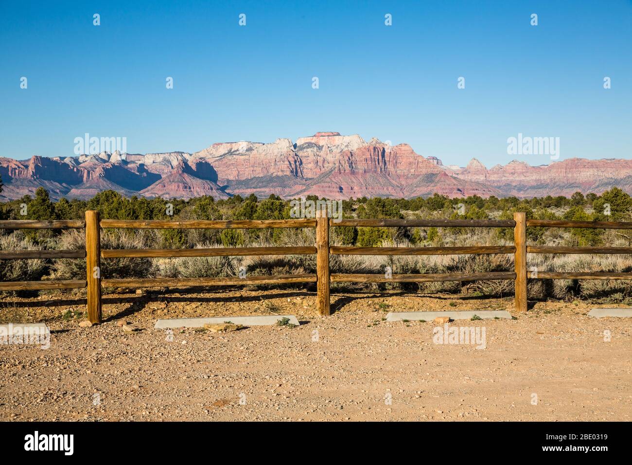Wooden fence along the edge of an empty trailhead parking area in the desert of Southern Utah. Stock Photo