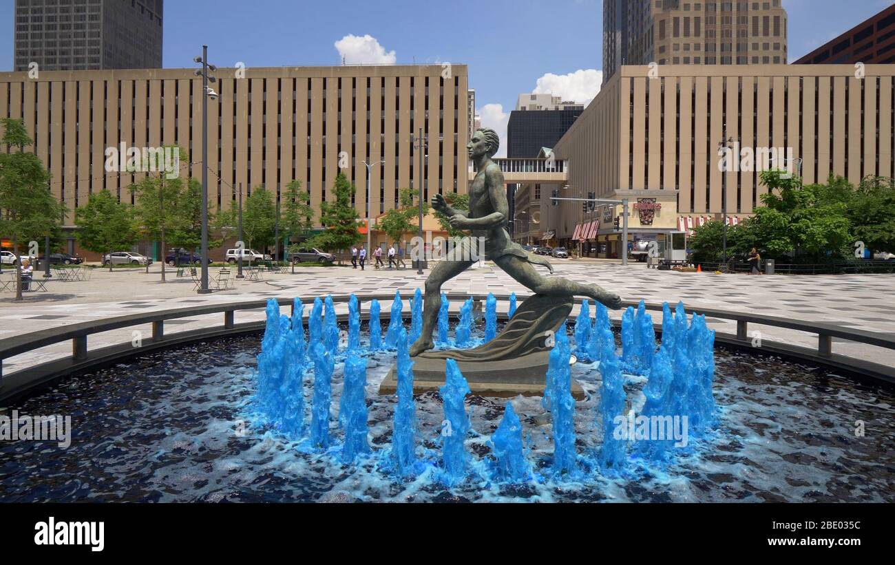 Blue water fountain with Runner Statue at Kiener Plaza Park in St