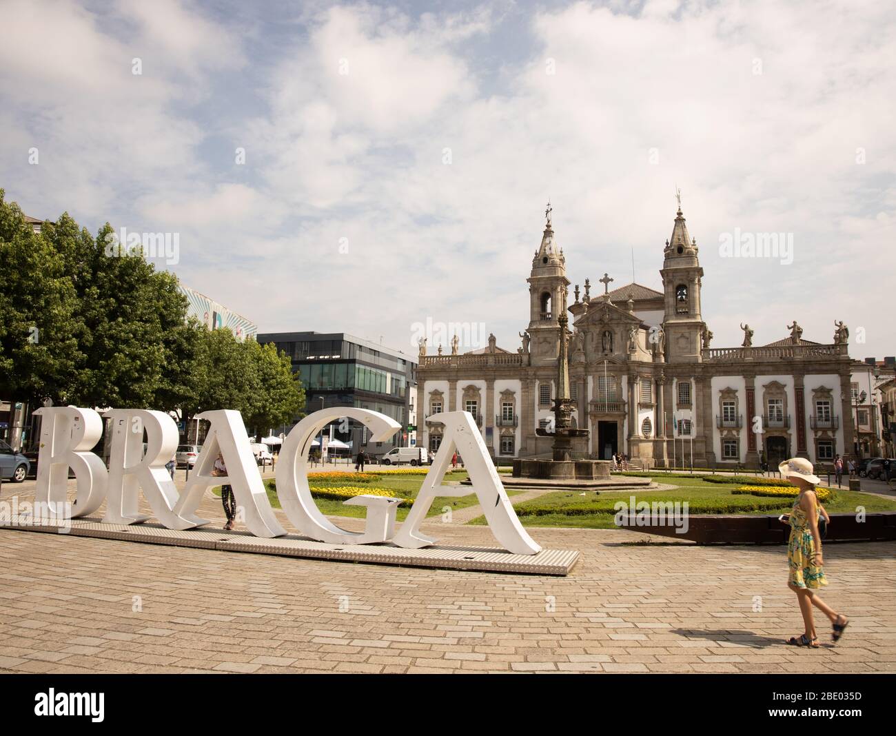 Large Braga sign with girl walking in foreground and hotel villa gale in background Braga, Portugal Stock Photo