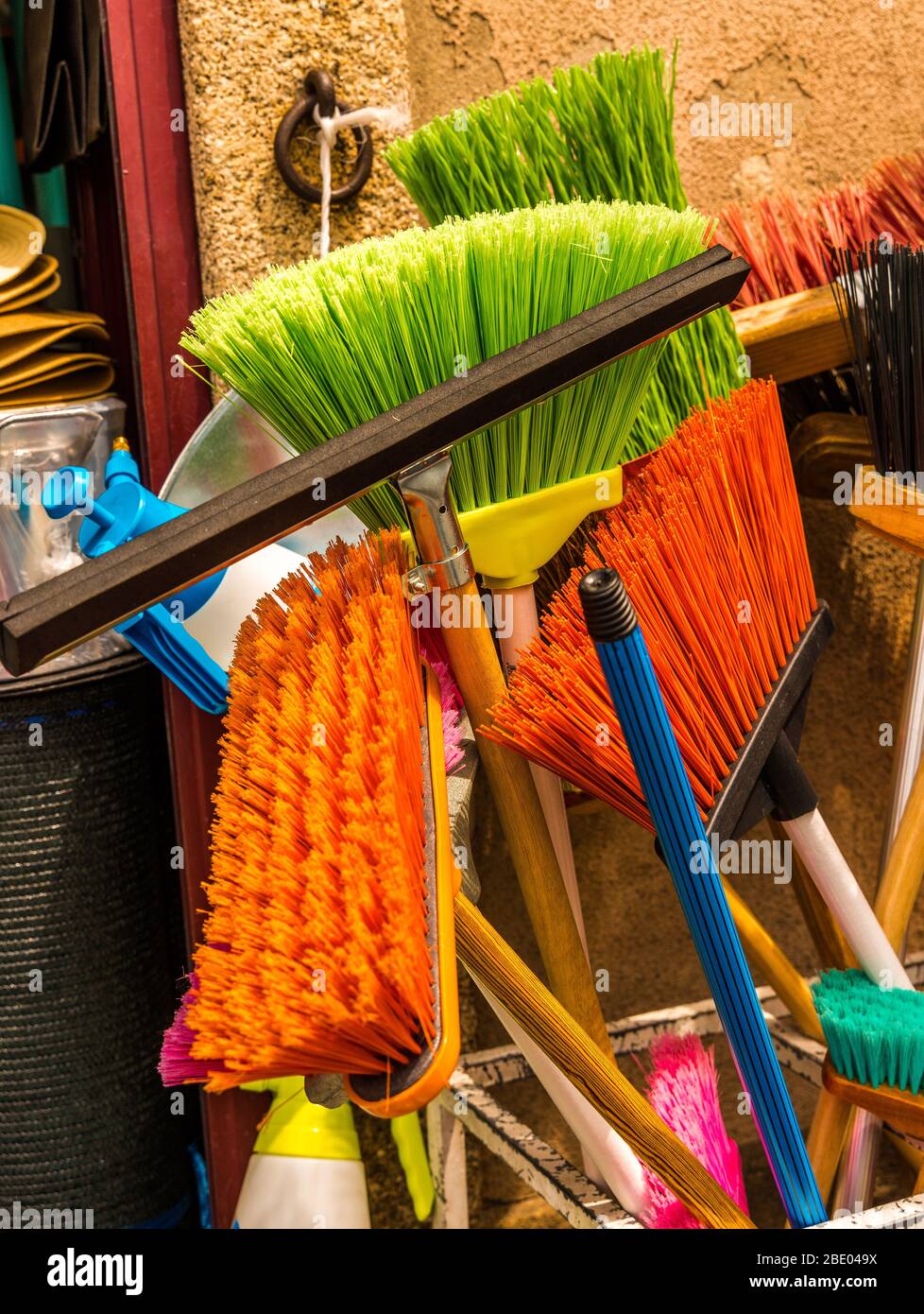 Colourful array of plastic sweeping brushes and brooms displayed Stock  Photo - Alamy