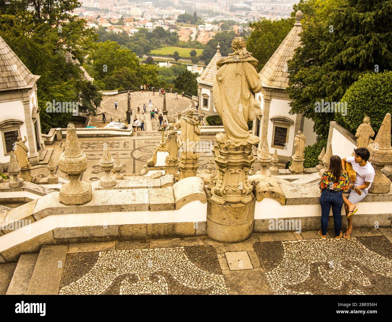Romantic scene with man playing guitar to his girlfriend at Bom Jesus do Monte a Portuguese sanctuary in Tenões, Braga, Portugal. Stock Photo