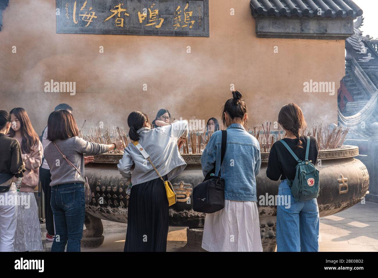 NANJING, CHINA - NOVEMBER 08: People burning incense sticks at Jiming Temple, a famous buddhist temple on November 08, 2019 in Nanjing Stock Photo
