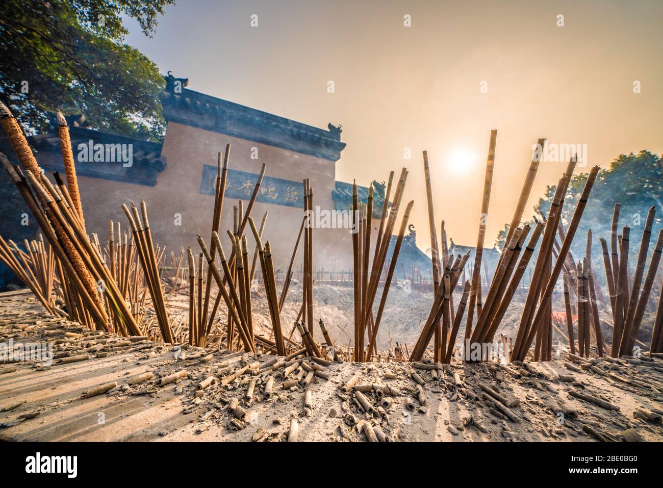 NANJING, CHINA - NOVEMBER 08: Incense sticks burning with the sunset shining through at Jiming buddhist temple on November 08, 2019 in Nanjing Stock Photo