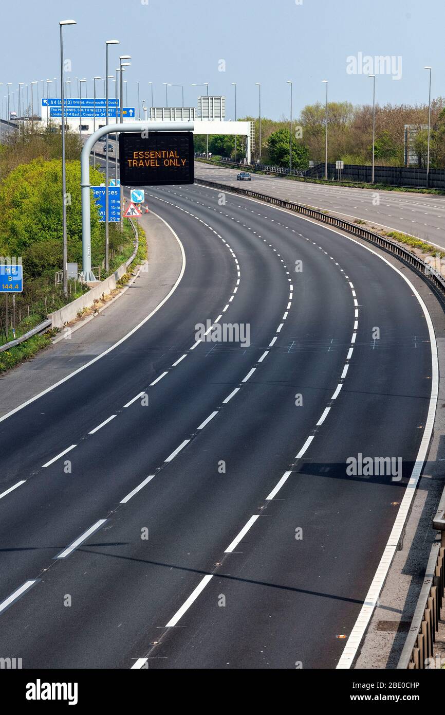 Information signs displaying 'Essential Travel Only' on the M5 near Bristol, as government restrictions continue to try and contain the coronavirus. Stock Photo