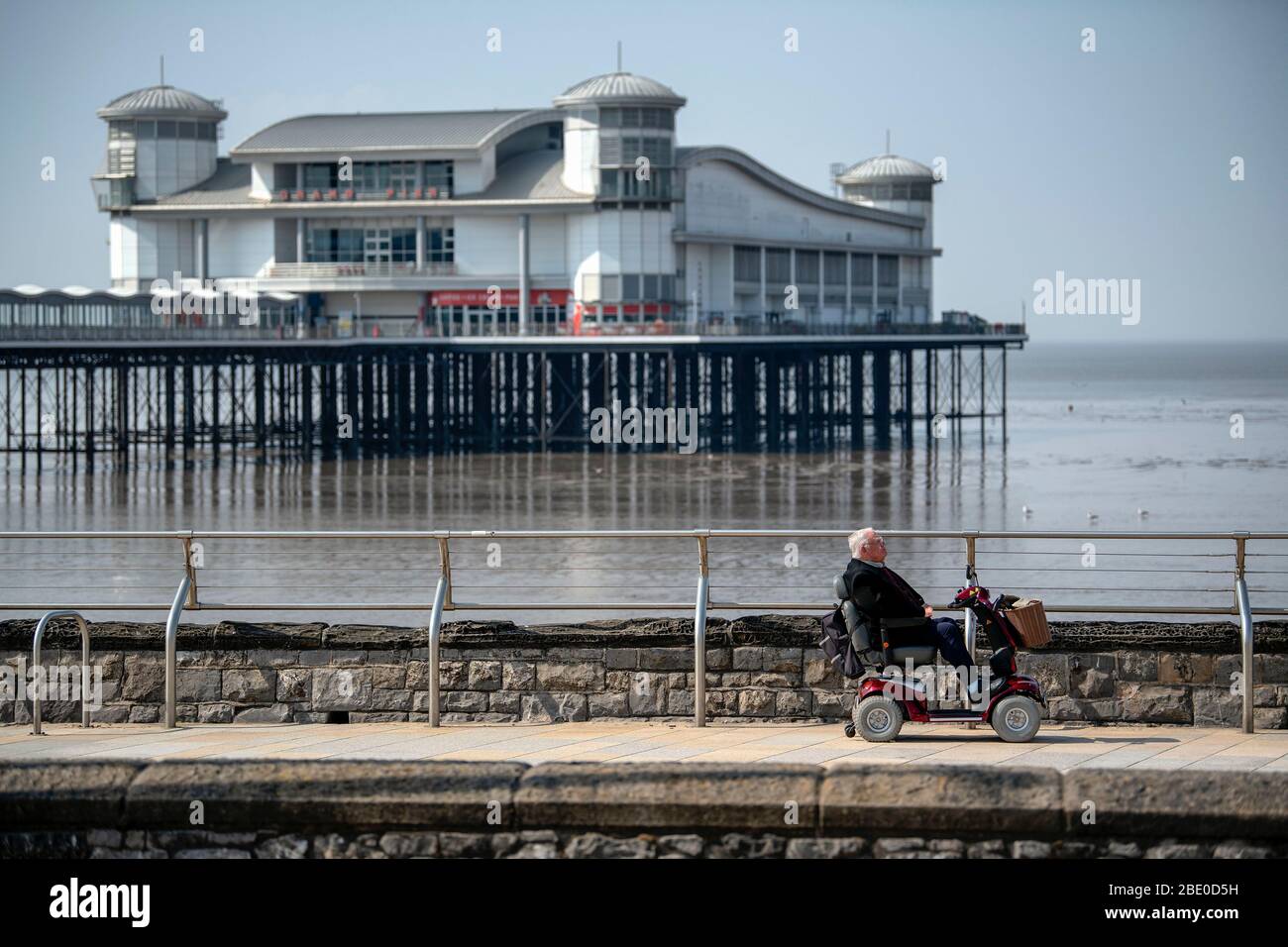 A man on a mobility scooter rides along Royal Parade past the Grand Pier in WestonsuperMare