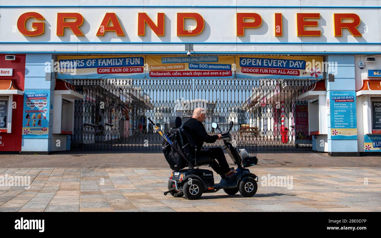 A man on a mobility scooter rides along Royal Parade past the Grand Pier in WestonsuperMare