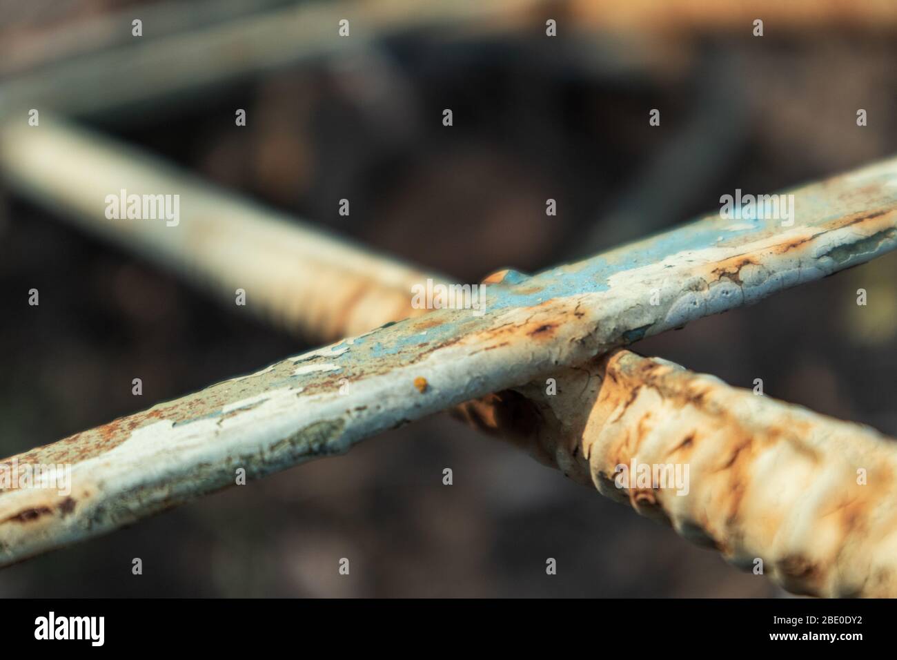 Old blue paint weathered rusty rough metal rods material details macro close-up background Stock Photo