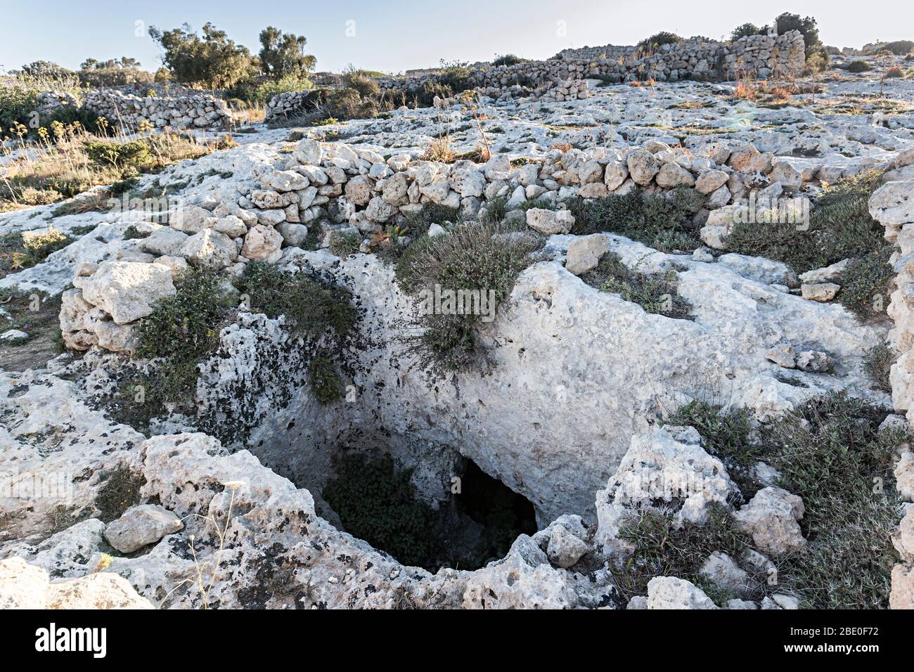 Rock cut shaft and chamber tomb at Misrah Ghar il-Kbir (Clapham Junction) near the Dingli cliffs at the troglodyte settlement Stock Photo