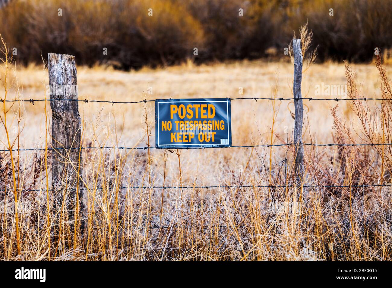 'Posted, No Trespassing, Keep Out' sign on central Colorado ranch fence Stock Photo